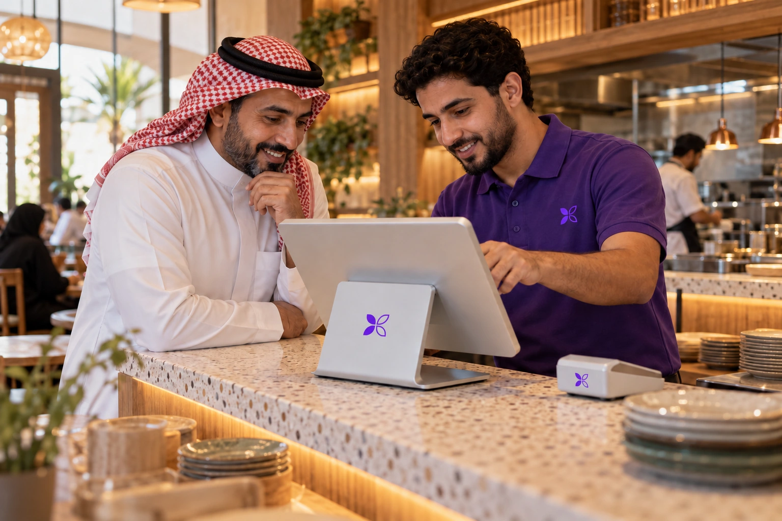 A MerX technician sets up a restaurant counter with the owner beside him.